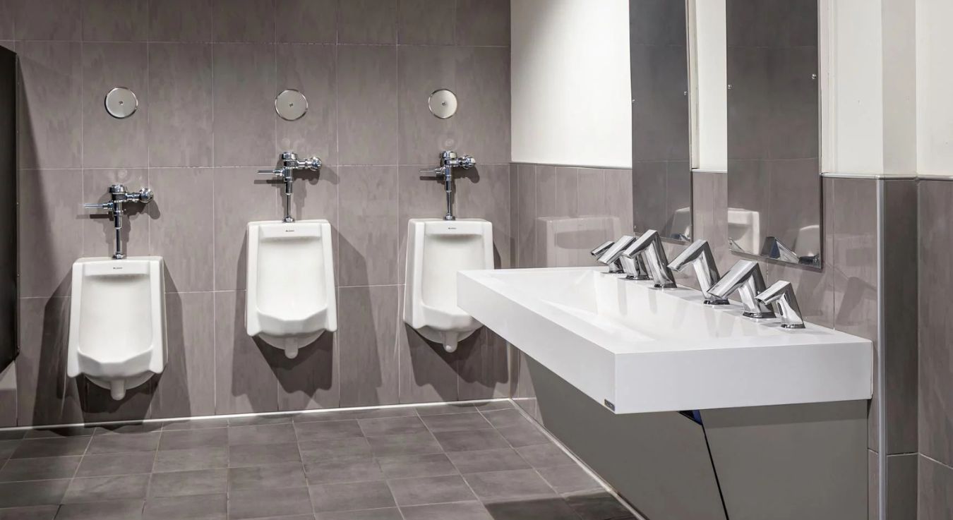 Student restroom area featuring Sloan urinals and sinks, combining functionality, hygienic design, and efficient water use.