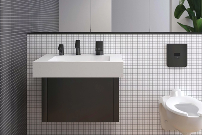 an elegant restroom featuring Sloan’s modern, minimalist finishes. With a sleek rectangular sink, matte black faucet, and wall-mounted white urinal, the space blends materials such as wood and ceramic to create a sophisticated, clean, and contemporary atmosphere.