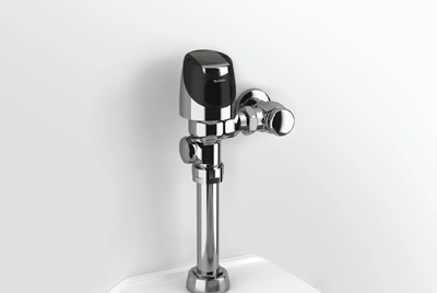 the Sloan® Flushometer, an icon of modern hydraulic engineering. Its chrome-plated, durable design embodies reliability, precision, and water efficiency