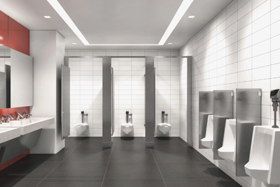 a modern commercial restroom featuring Sloan® flushometers on each fixture.
