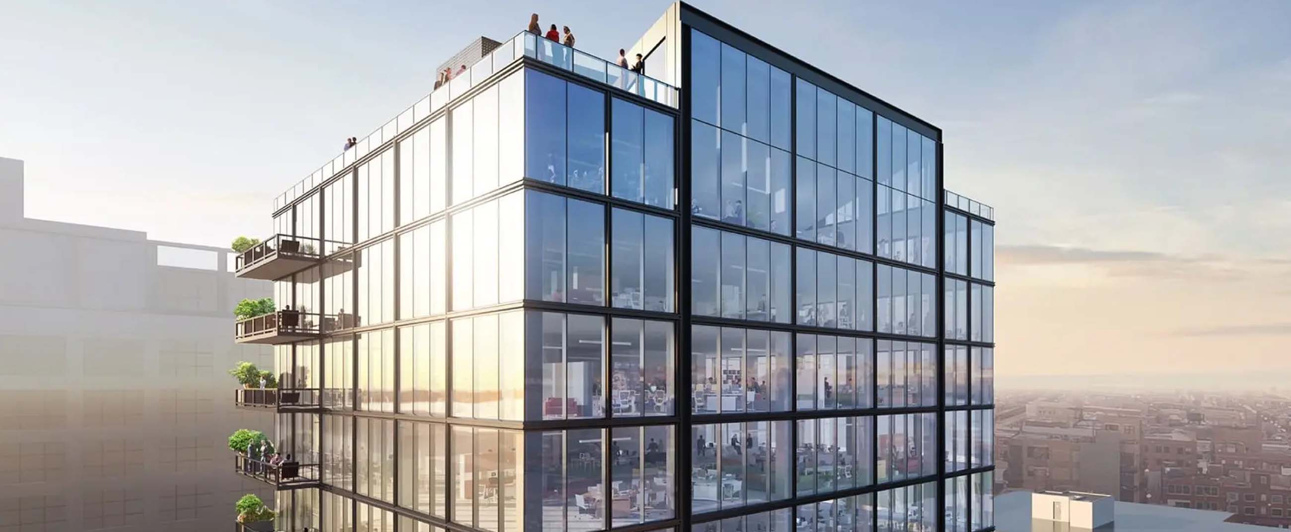 Fulton East, a commercial office building in Chicago known for its modern and sustainable architecture. Its floor-to-ceiling glass façade maximizes natural light, while private balconies and rooftop terraces provide open-air spaces for occupants.