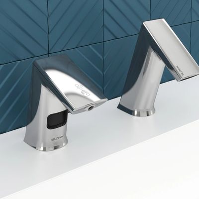 Sloan automatic faucet and soap dispenser in chrome finish, on a white countertop with dark blue geometric tile background.