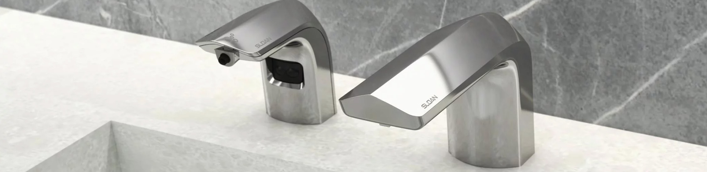 a set of Sloan® automatic dispensers featuring a modern chrome finish, installed above a light-colored solid surface sink.