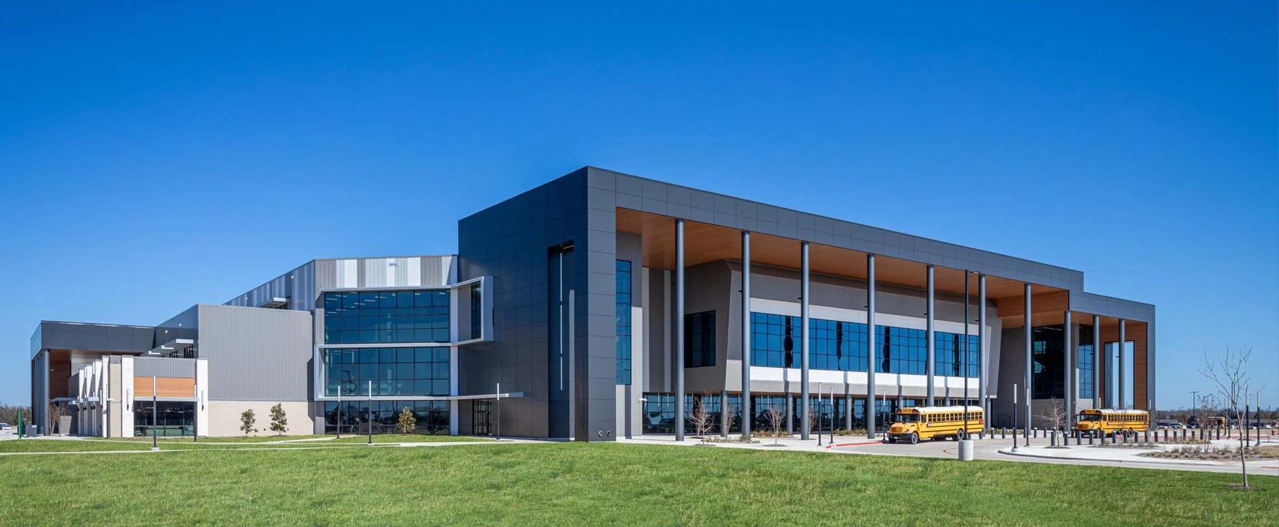 the Keith Bell Opportunity Central (The OC), a modern educational and community complex located in Forney, Texas. The architecture features clean lines, expansive windows, and contemporary materials that embody its innovative mission — providing a multifunctional space for education, career development, and community engagement.
