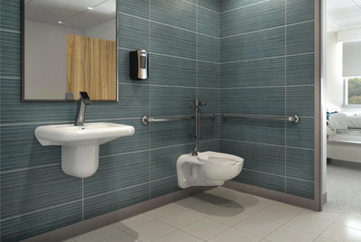 an institutional restroom designed for accessibility, featuring Sloan® products.