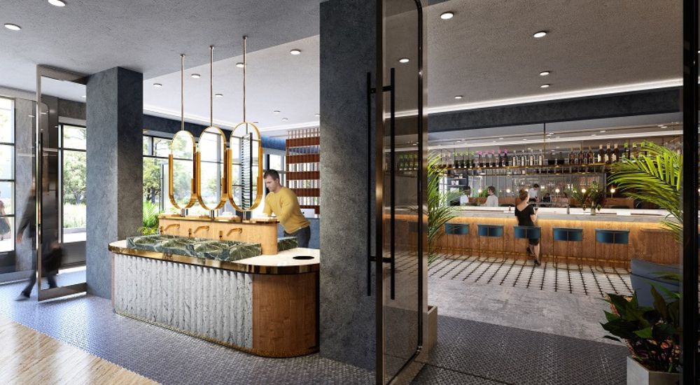 Modern restaurant entrance with a marble and wood reception counter, warm lighting, and an elegant bar in the background, decorated with plants and contemporary details.