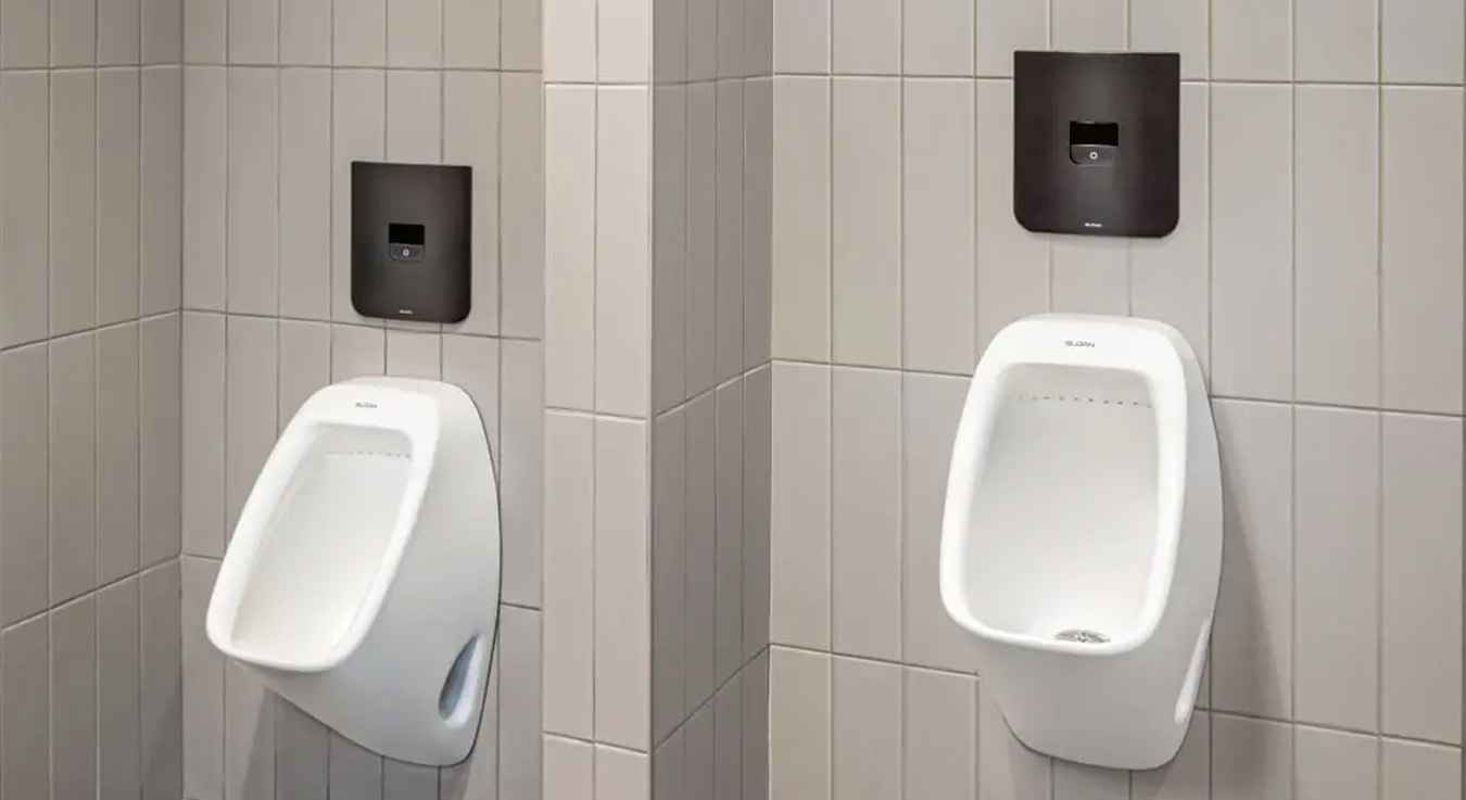 Sloan urinals installed at SPC Mechanical Headquarters, featuring concealed electronic sensor flush valves in a refined matte black finish.