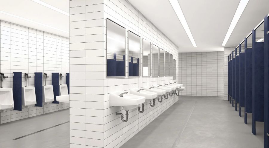 Spacious public restroom with sinks, urinals, and stalls in white and navy tones, designed for entertainment or high-traffic venues.