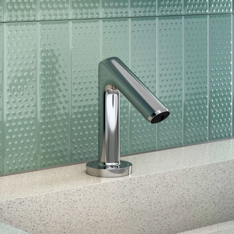 Sloan automatic chrome faucet with sleek cylindrical design on a solid surface countertop and textured aqua green tile backsplash.