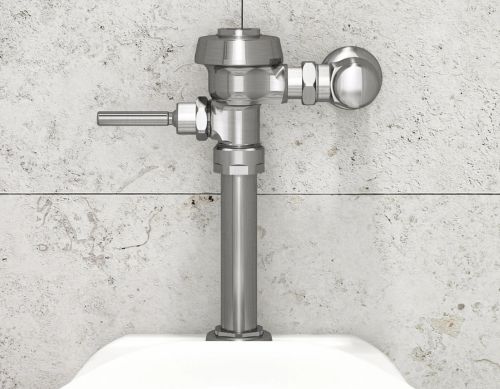 Sloan manual flushometer in polished chrome finish installed above a toilet against a light gray tiled wall.