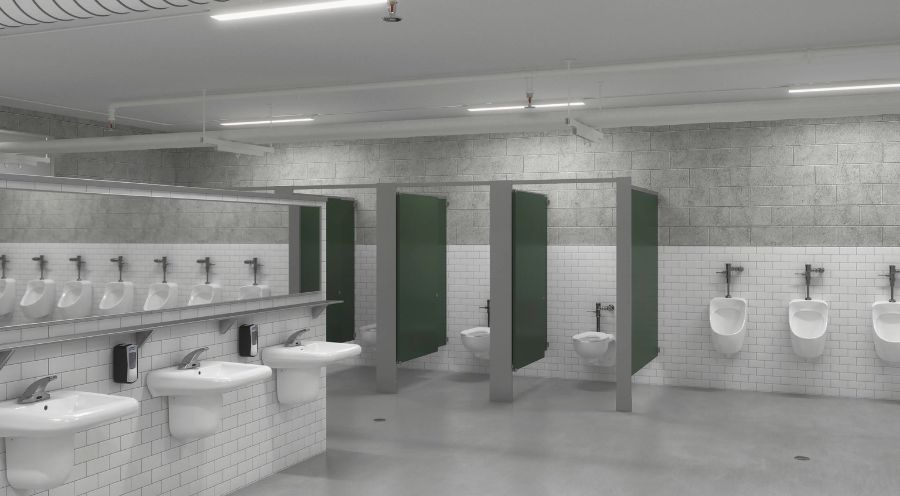 Baño público amplio con lavabos, urinarios y cabinas en tonos gris y verde, diseñado con materiales duraderos y accesorios automáticos.