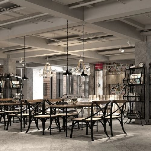 Stylish restaurant interior with industrial décor, wooden tables, and hanging lights.