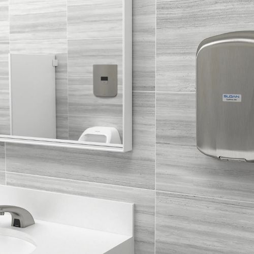Modern restroom featuring a stainless steel Sloan Optima Air hand dryer mounted on the wall next to a large mirror and white countertop sink.