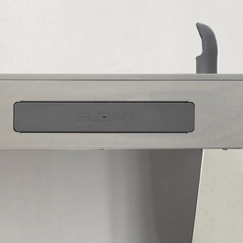 Stainless steel Sloan drinking fountain with gray front panel and ergonomic spout.