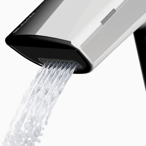Close-up of water flow from a Sloan automatic faucet showing smooth, splash-free stream.