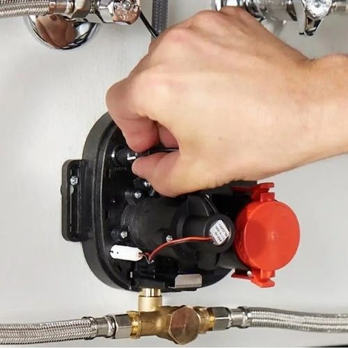 Hand connecting Sloan faucet control module under sink