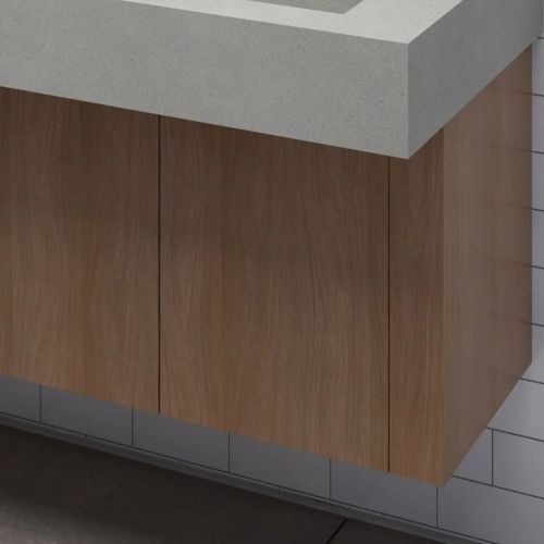 Detalle de un mueble de madera con encimera gris suspendida, que muestra el diseño limpio y contemporáneo del lavabo.