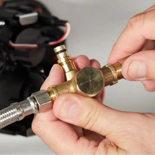 Hands assembling Sloan brass faucet valve