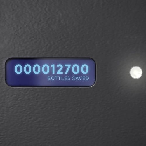 Digital display on a Sloan bottle filler showing the counter reading “12,700 bottles saved.”