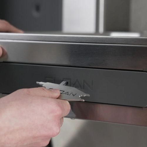 Hands using a Sloan tool to open the maintenance panel of a stainless steel drinking fountain.