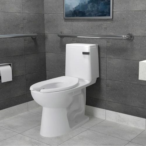 White Sloan toilet installed in a gray-tiled accessible restroom with grab bars on both sides.