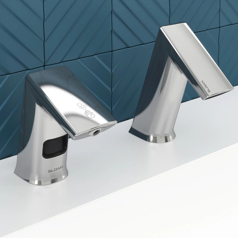 Sloan automatic faucet and soap dispenser in chrome finish, installed on a white countertop with a dark blue geometric tile wall in the background.