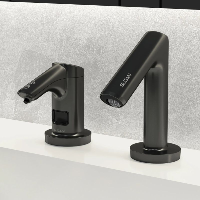 Sloan automatic faucet and soap dispenser in matte black finish, installed on a white countertop with a light gray textured wall.