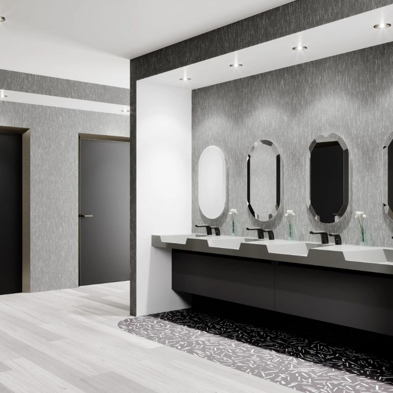 Modern commercial restroom with a row of Sloan faucets and mirrors over a sleek solid surface sink.
