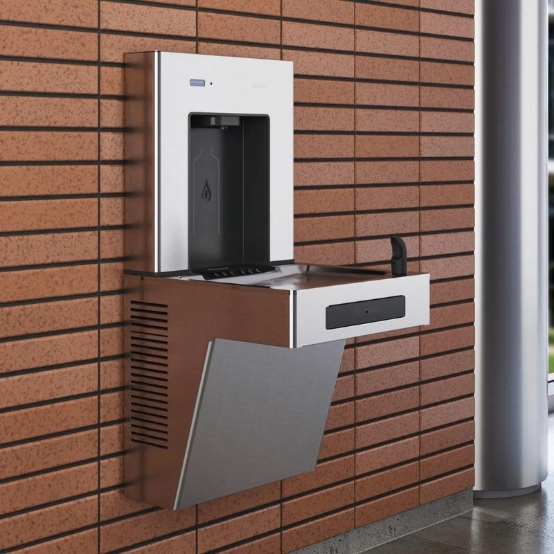 Stainless steel Sloan wall-mounted water dispenser with integrated drinking fountain installed on a brick wall.