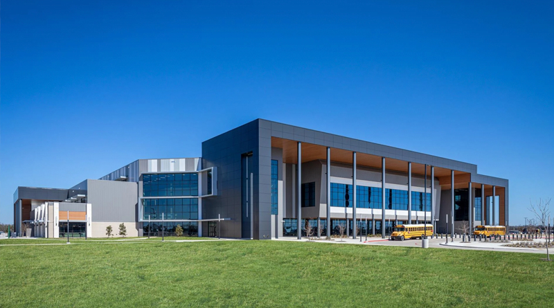 the Keith Bell Opportunity Central (The OC), a modern educational and community complex located in Forney, Texas. The architecture features clean lines, expansive windows, and contemporary materials that embody its innovative mission — providing a multifunctional space for education, career development, and community engagement.