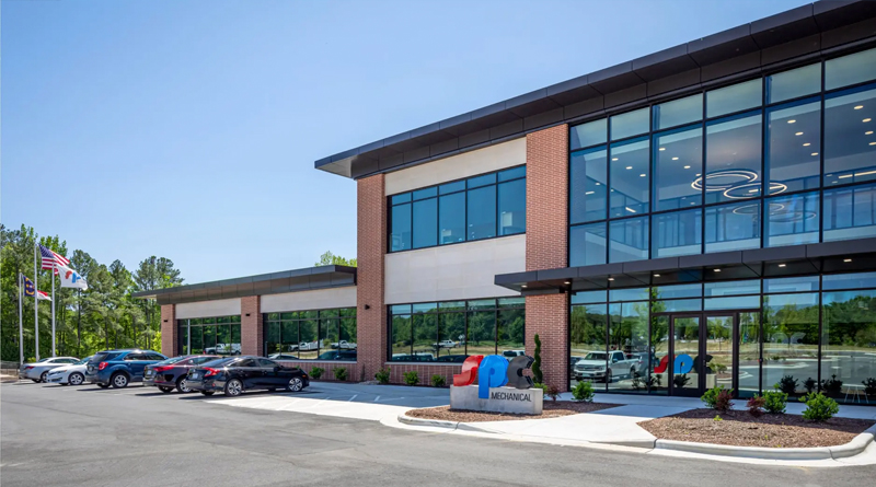 the SPC Mechanical Headquarters, a contemporary corporate building featuring clean lines, expansive windows, and modern materials such as brick, glass, and metal. Its architecture conveys a sense of innovation, transparency, and corporate strength, perfectly aligned with the company’s technical and professional identity.